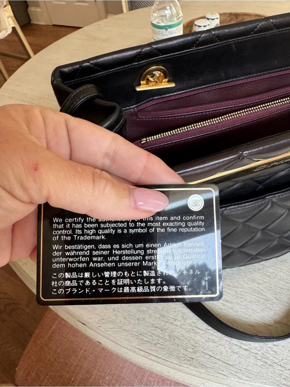 CHANEL Black Quilted Leather Shoulder Bag with Gold-Tone Plate and CC Charm